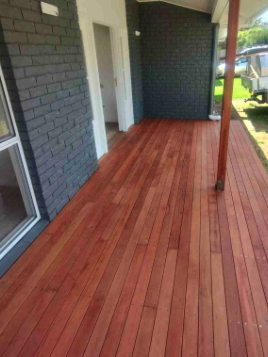 Stained porch decking against brick